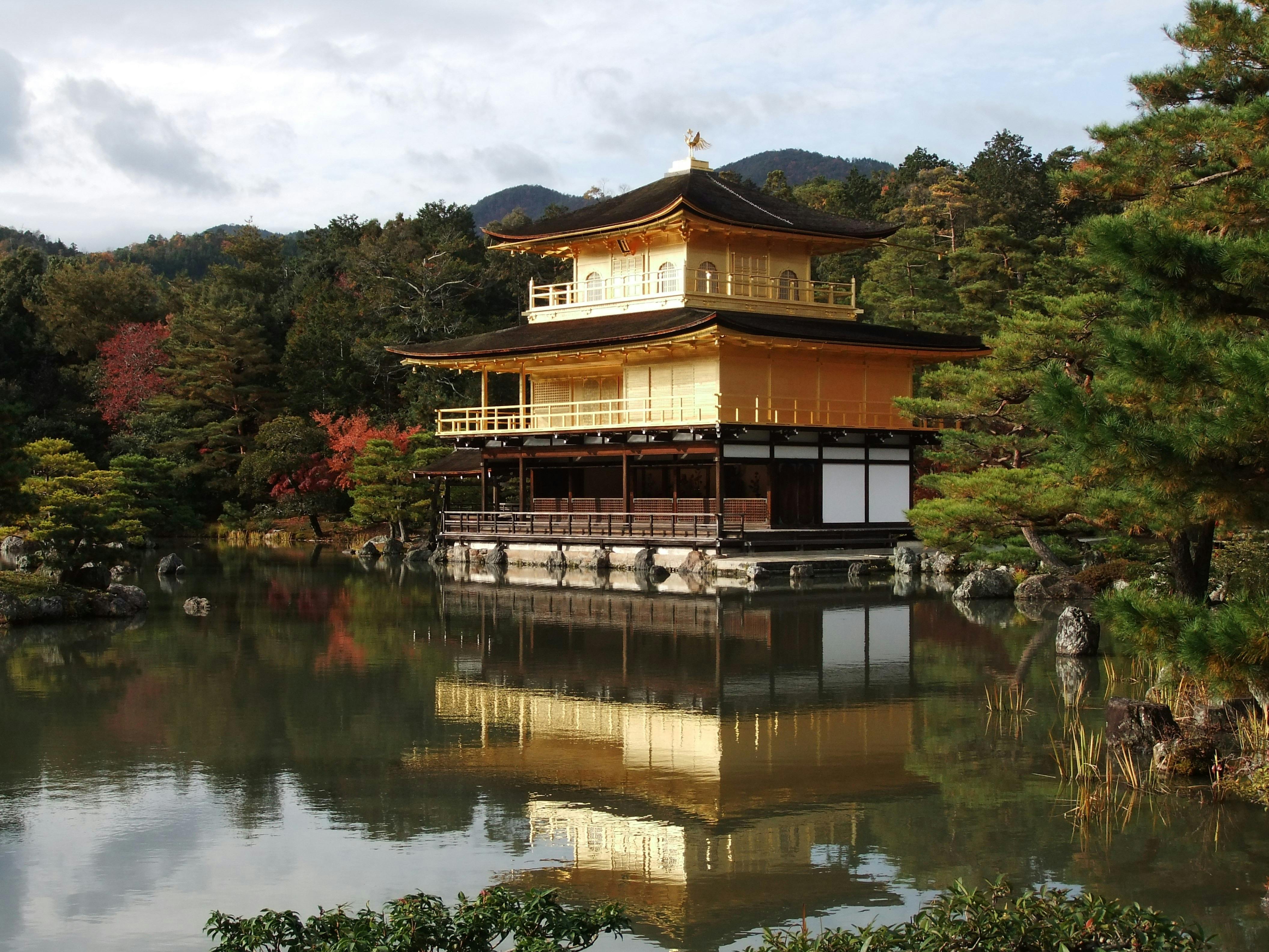 Golden Pavilion in Kyoto surrounded by red maple leaves during autumn