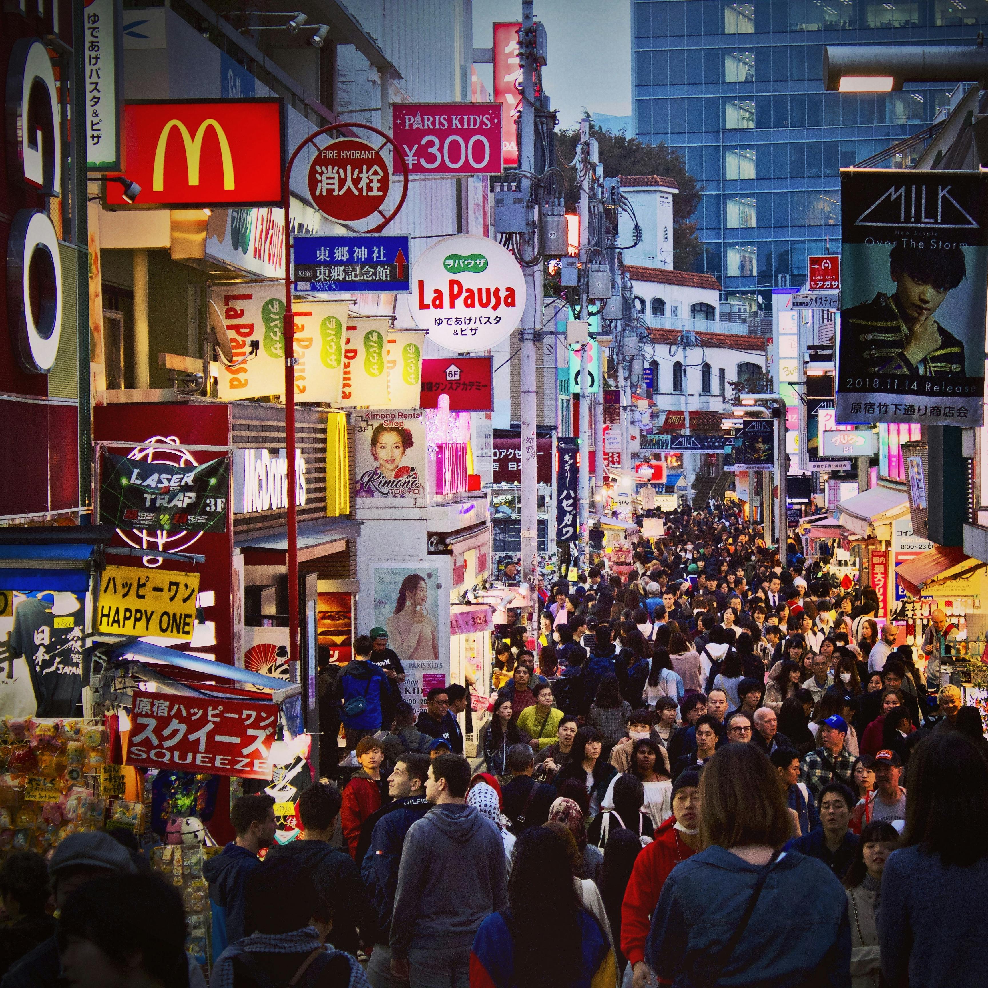 Bustling Shibuya street in Tokyo filled with lights, crowds, and vibrant billboards
