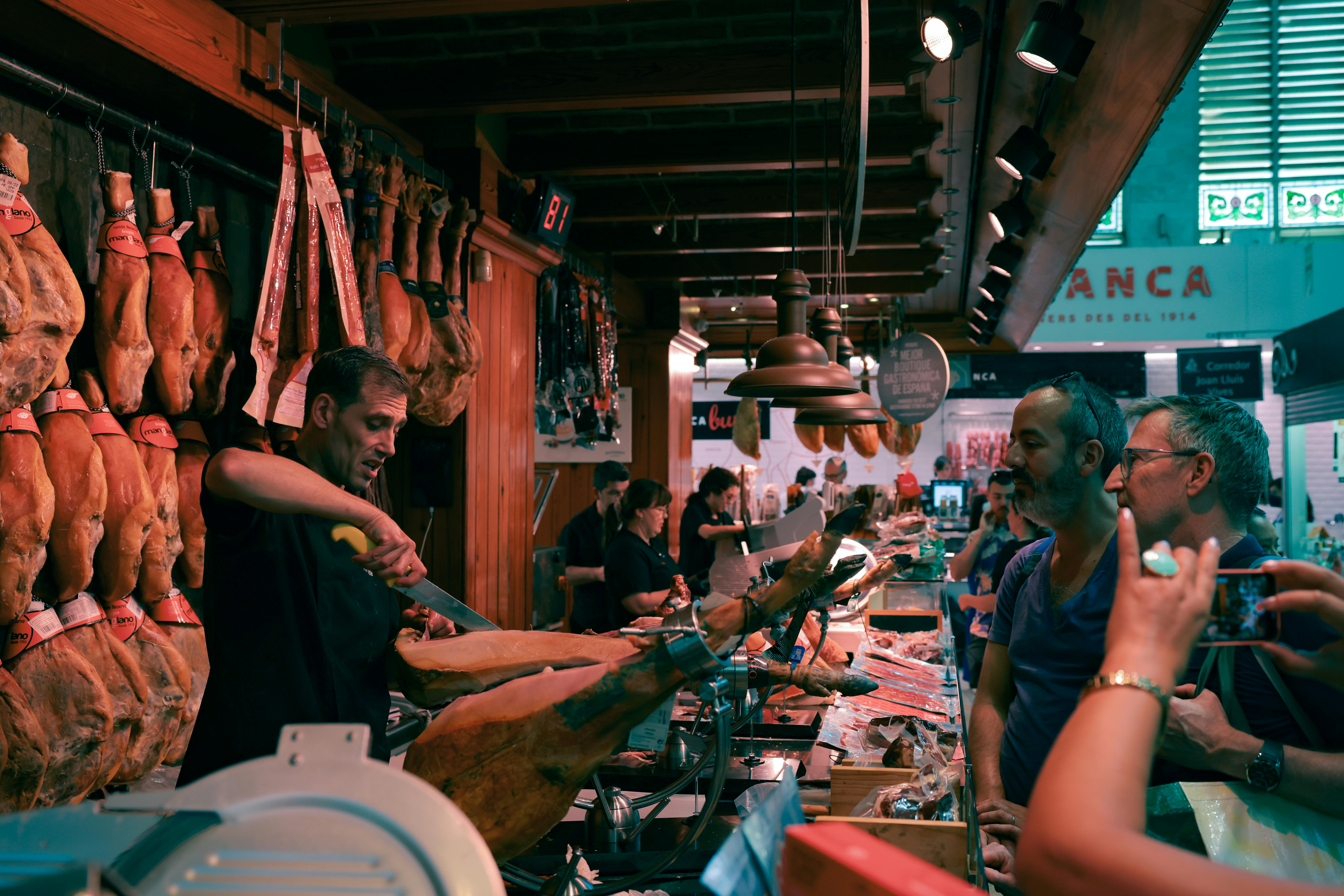 Market vendor slicing Jamón Ibérico in Seville