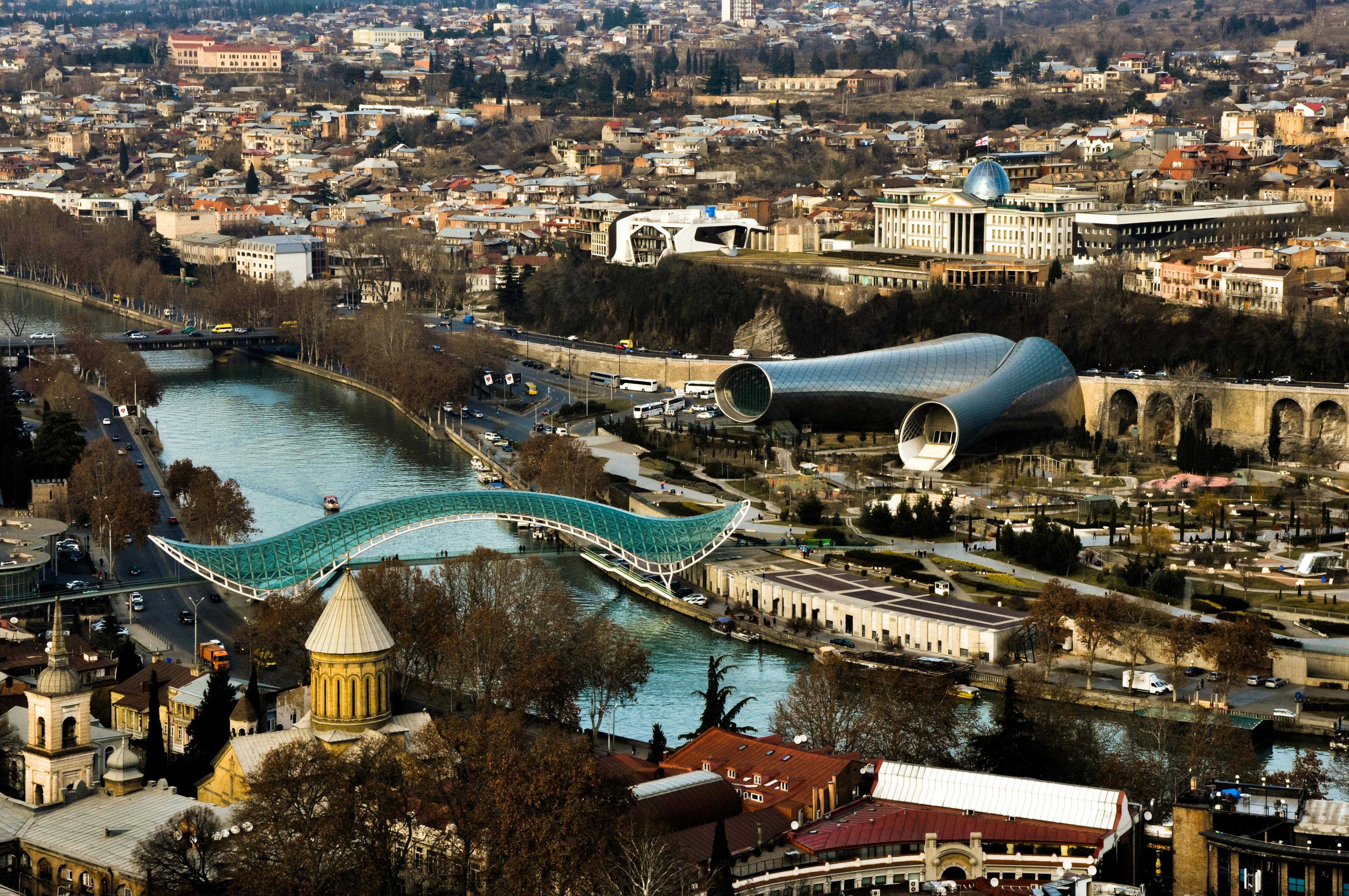 Colorful Tbilisi old town with cable cars and mountains in background