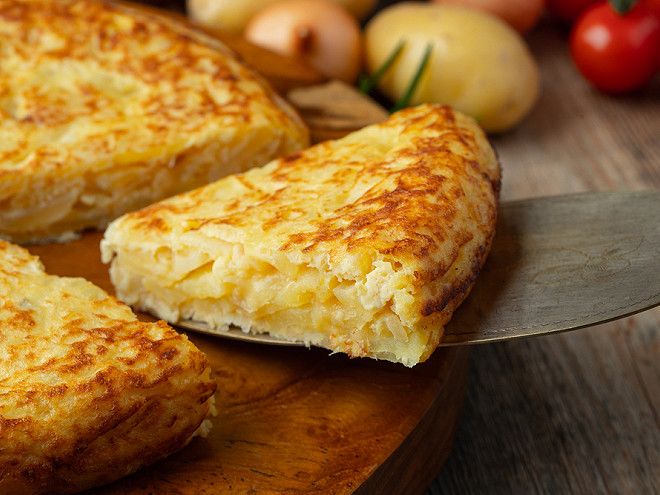 Spanish tortilla cut open, showing layers of potato and egg